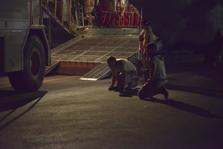 Aerial porters from the 8th Expeditionary Air Mobility Squadron guide the driver aboard a P-19 Aircraft Rescue Fire Fighting vehicle onto a C-130J Hercules assigned to the 746th Expeditionary Airlift Squadron October 12, 2015 at Al Udeid Air Base, Qatar. (U.S. Air Force photo/Staff Sgt. Alexandre Montes)