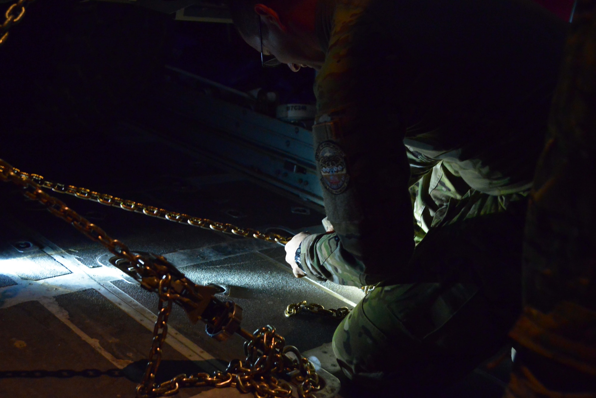 Tech Sgt. Wyatt Lewis, 746th Expeditionary Airlift Squadron crew chief, checks the tie-down of a P-19 Aircraft Rescue Fire Fighting vehicle inside a C-130J Hercules assigned to the 746th EAS October 12, 2015 at Al Udeid Air Base, Qatar. Aircrew from the 746th EAS received help from Airmen of the 8th Expeditionary Air Mobility Squadron to load the P-19 ARFF vehicle that will be used at a Forward Operating Base. (U.S. Air Force photo/Staff Sgt. Alexandre Montes)