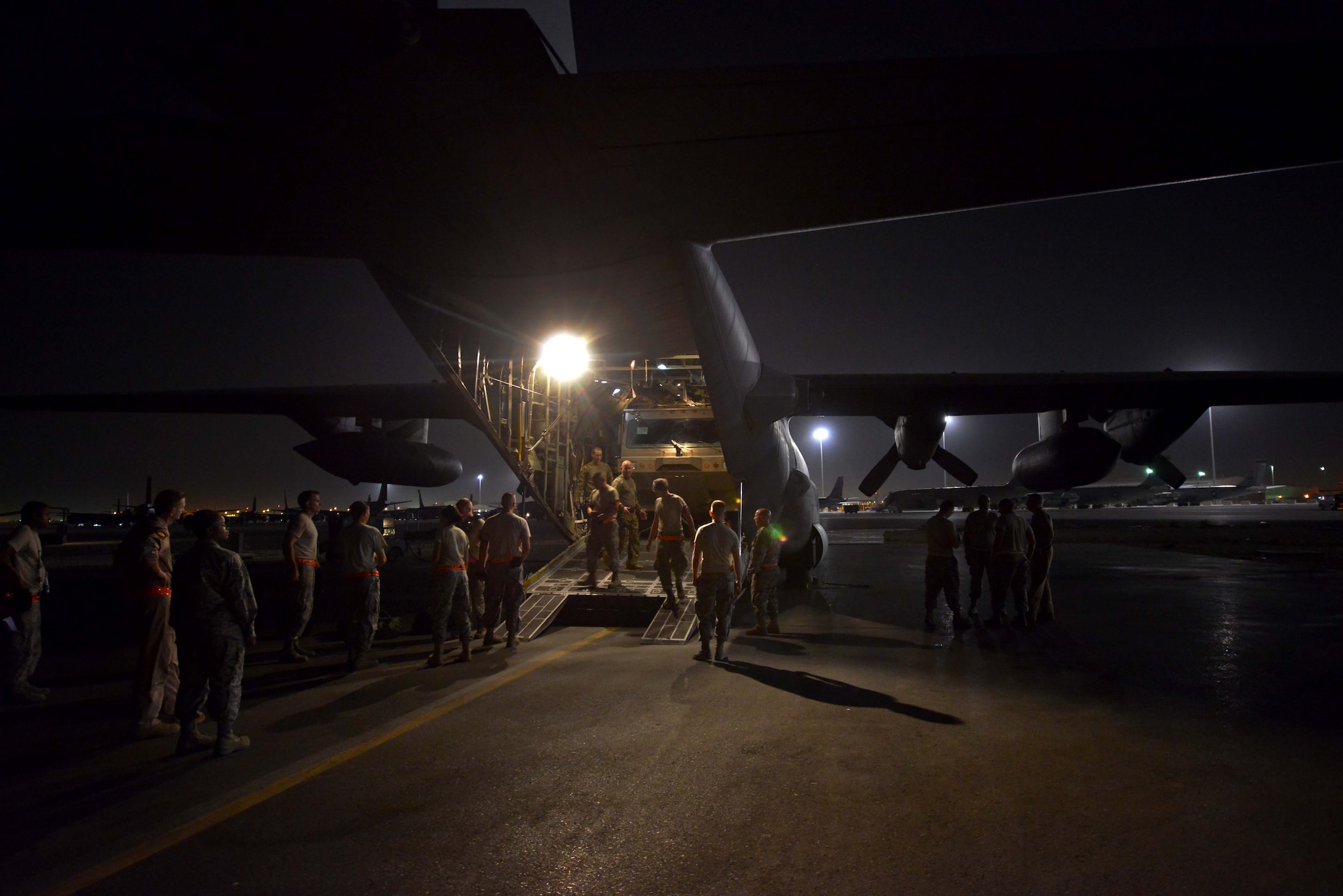 Aircrew of the 746th Expeditionary Airlift Squadron and aerial porters from the 8th Expeditionary Air Mobility Squadron complete final safety checks of a P-19 Aircraft Rescue Fire Fighting vehicle tie-down inside a C-130J Hercules prior to closing the cargo door   October 12, 2015 at Al Udeid Air Base, Qatar. Aircrew from the 746th EAS received help from Airmen of the 8th EAMS to load the P-19 ARFF vehicle that will be used at a Forward Operating Base. (U.S. Air Force photo/Staff Sgt. Alexandre Montes)