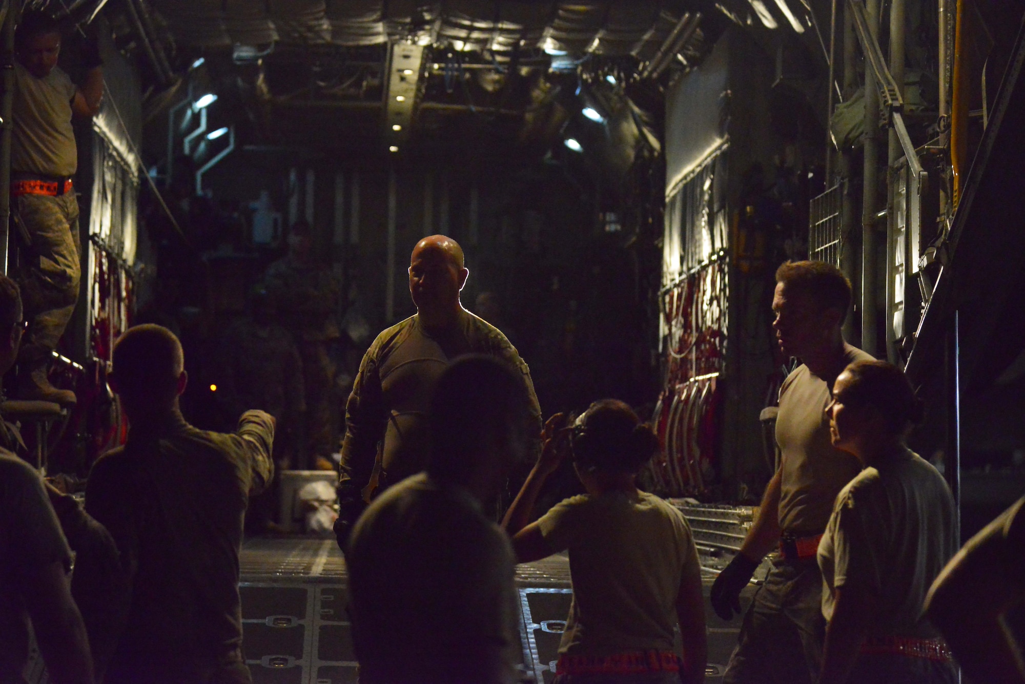 Chief MSgt. James Rickels, 746th Expeditionary Airlift Squadron, goes over instructions to 379th Expeditionary Aircraft Maintenance Squadron Airmen and aerial porters from the 8th Expeditionary Air Mobility Squadron on loading a 23,000 pound P-19 Aircraft Rescue Fire Fighting vehicle onto a C-130J Hercules October 12, 2015 at Al Udeid Air Base, Qatar. Aircrew from the 746th EAS received help from Airmen of the 8th EAMS to load the P-19 ARFF vehicle that will be used at a Forward Operating Base. (U.S. Air Force photo/Staff Sgt. Alexandre Montes)