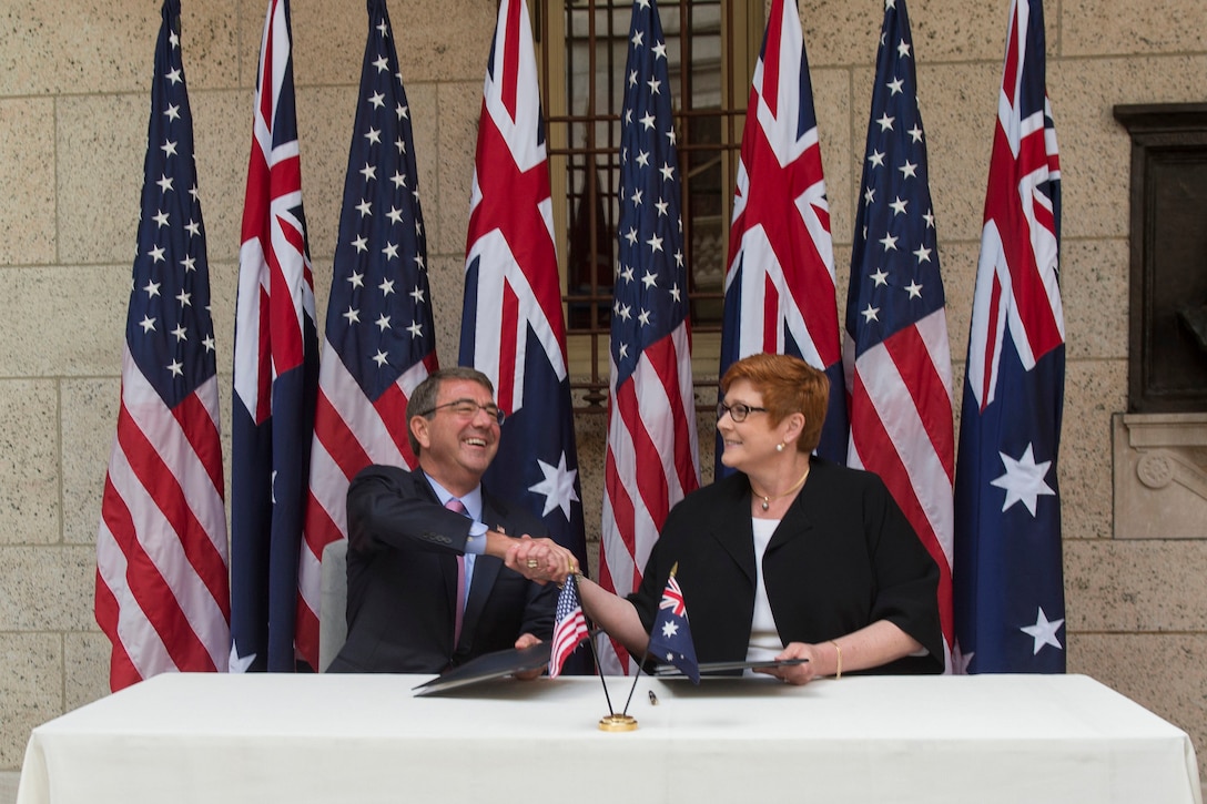 U.S. Defense Secretary Ash Carter and Australian Defense Minister Marise Payne shake hands after signing a U.S.-Australia defense statement at the Boston Public Library during the Australia-U.S. Ministerial Consultations in Boston, Oct. 13, 2015. DoD photo by Air Force Senior Master Sgt. Adrian Cadiz