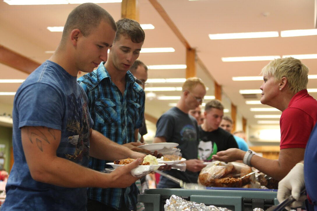 Lance Cpl. William Jackson serves himself food while attending an appreciation meal during the Military Fun Day at Cape Lookout Island, N.C., Oct. 9, 2015. The Carteret Military Affairs Committee hosted more than 80 service members and their guests during their visit to the Waterfowl Museum and Cape Lookout as a day of appreciation for service members and the dedication they uphold to their duties.  Jackson is a fixed wing aircraft mechanic with Marine Attack Training Squadron-203.