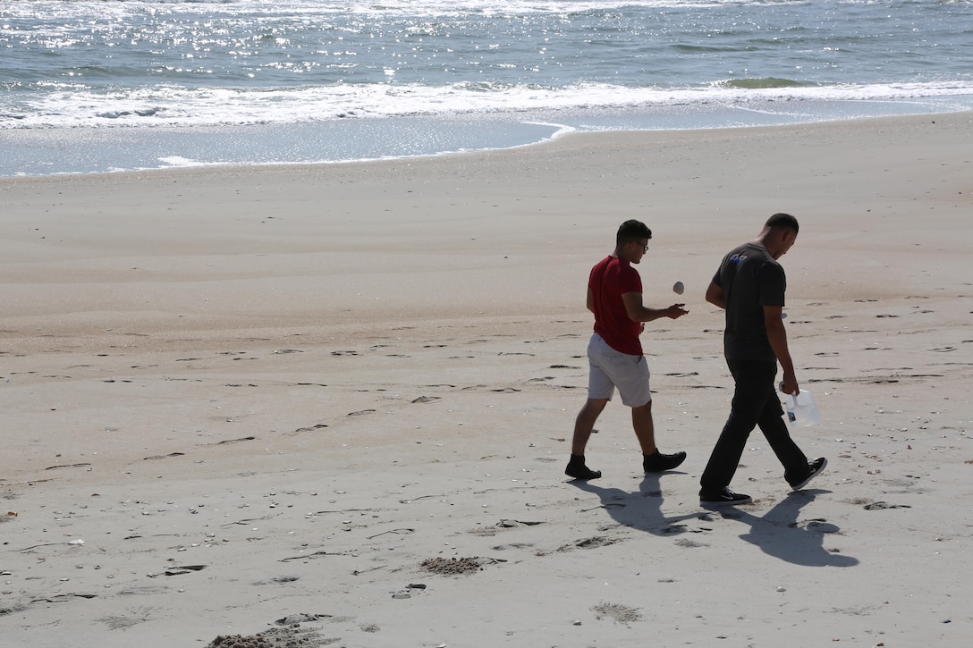 Service members and their guests roam the shoreline during the Military Fun Day at Cape Lookout Island, N.C., Oct. 9, 2015. The Carteret Military Affairs Committee hosted more than 80 service members and their guests during their visit to the Waterfowl Museum and Cape Lookout as a day of appreciation for service members and the dedication they uphold to their duties. 
