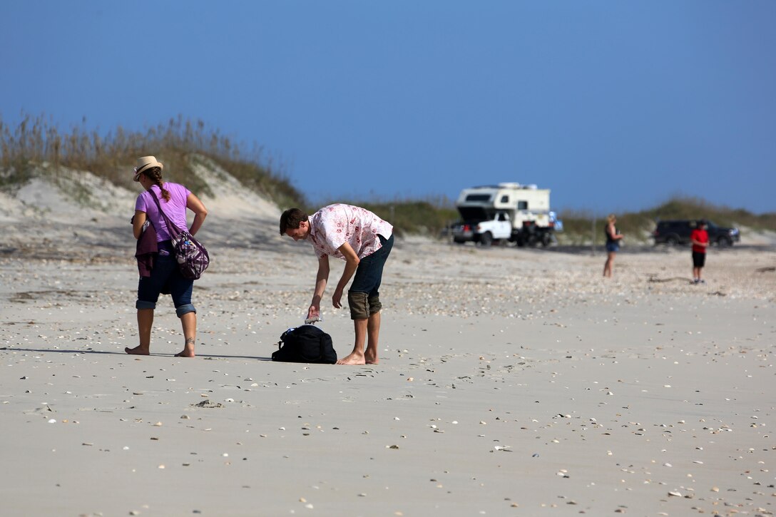 Service members and their guests explore the Cape Lookout beach during the Military Fun Day at Cape Lookout Island, N.C., Oct. 9, 2015. The Carteret Military Affairs Committee hosted more than 80 service members and their guests during their visit to the Waterfowl Museum and Cape Lookout as a day of appreciation for service members and the dedication they uphold to their duties. 