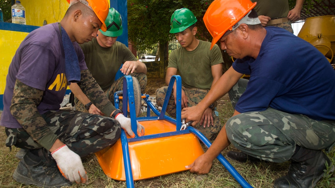 Philippine Navy Seabees, members of their naval construction battalions,  and U.S. Marines work together to fix a wheelbarrow while preparing to begin working on the humanitarian civic assistance project at Concepcion Elementary School Sept. 24, during Amphibious Landing Exercise 2015. PHIBLEX 15 is an annual, bilateral training exercise conducted by members of the Armed Forces of the Philippines alongside U.S. Marine and Navy Forces. It focuses on strengthening the partnership and relationships between the two nations across a range of military operations, including disaster relief and complex expeditionary operations. The Marines are with 9th Engineer Support Battalion, 3rd Marine Logistics Group, III Marine Expeditionary Force. 