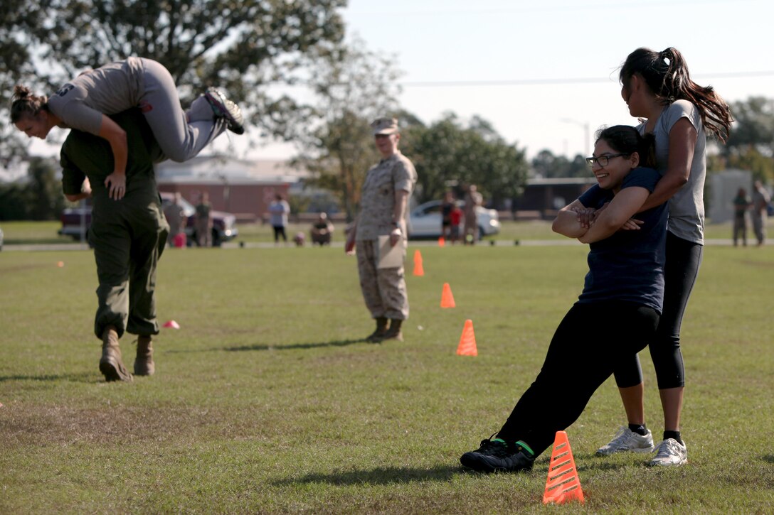 Marines and their spouses participate in a Combat Fitness Test during the second annual Jayne and John Wayne Day hosted by Marine Aviation Logistics Squadron 14 at Marine Corps Air Station Cherry Point, N.C., Oct. 9, 2015. Family members toured their service member’s workspaces, participate in a portion of the Marines’ CFT and turned a few wrenches all to build relationships with the command, meet other families and build camaraderie with the unit. MALS-14 provides aviation logistics support, guidance, and direction to Marine Aircraft Group 14 squadrons including maintenance for aircraft and aeronautical components.