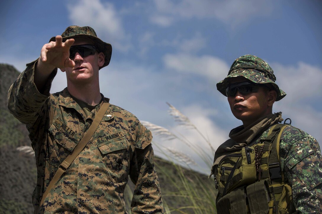 U.S. Marine Corps 1st Lt. Clarence J. Miller, left, and 2nd Lt. Edilberto V. Villafria of the Phillipine marines discuss planning a platoon movement during Amphibious Landing Exercise 2015 at Crow Valley, Philippines, Oct. 2, 2015. Miller is a platoon commander assigned to Echo Company, 2nd Battalion, 5th Marine Regiment. "PHIBLEX 15" is an annual bilateral training exercise conducted with the Philippine military in order to enhance interoperability and working relationships in disaster relief response and other complex expeditionary operations. U.S. Marine Corps photo by Lance Cpl. Juan Bustos
