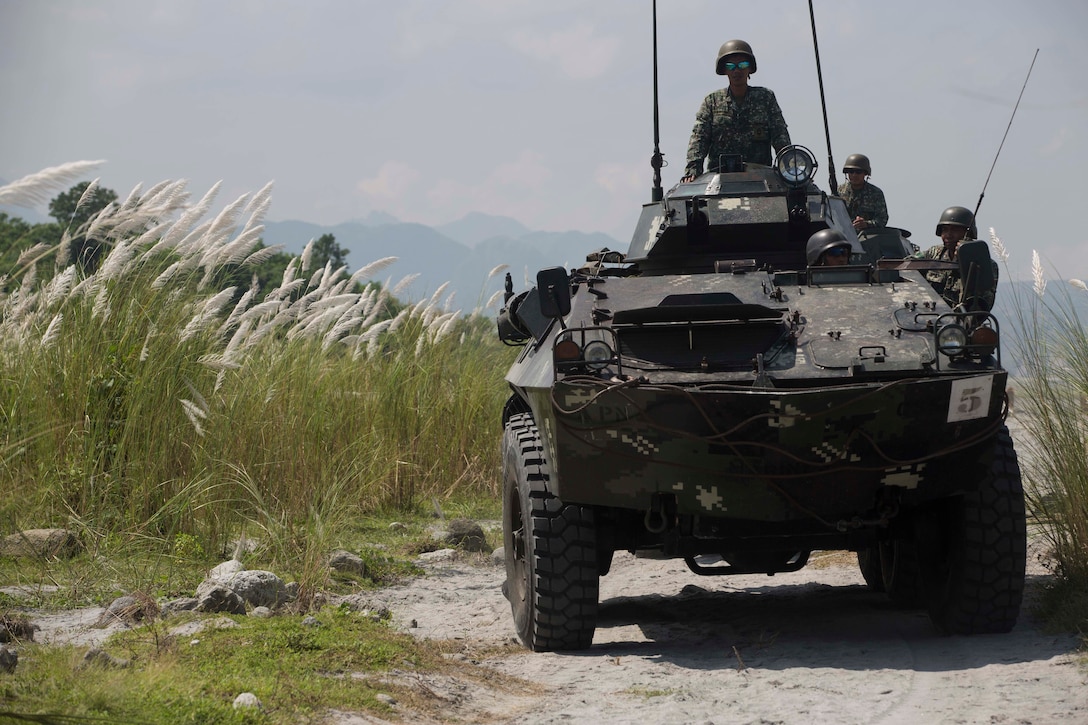Philippine Marines ride in a light armored vehicle during platoon movement training at Crow Valley, Philippines, Oct. 2, 2015, as part of Amphibious Landing Exercise 2015. U.S. Marine Corps photo by Lance Cpl. Juan Bustos