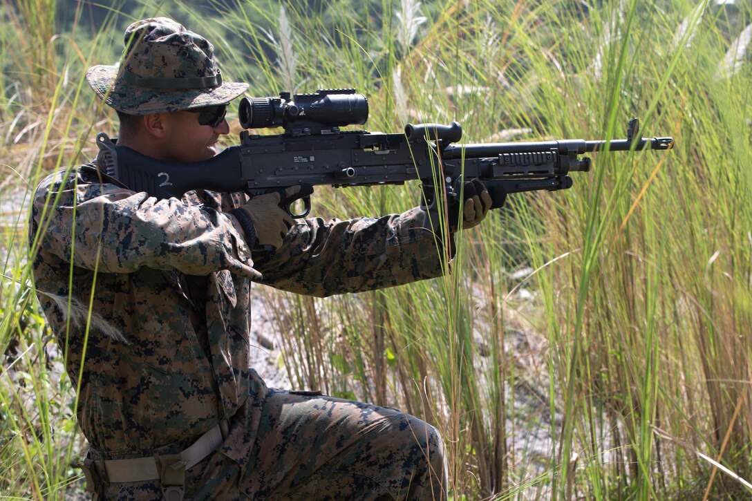 A U.S. Marine aims his weapon during platoon movement training at Crow Valley, Philippines, Oct. 2, 2015, as part of Amphibious Landing Exercise 2015. U.S. Marine Corps photo by Lance Cpl. Juan Bustos