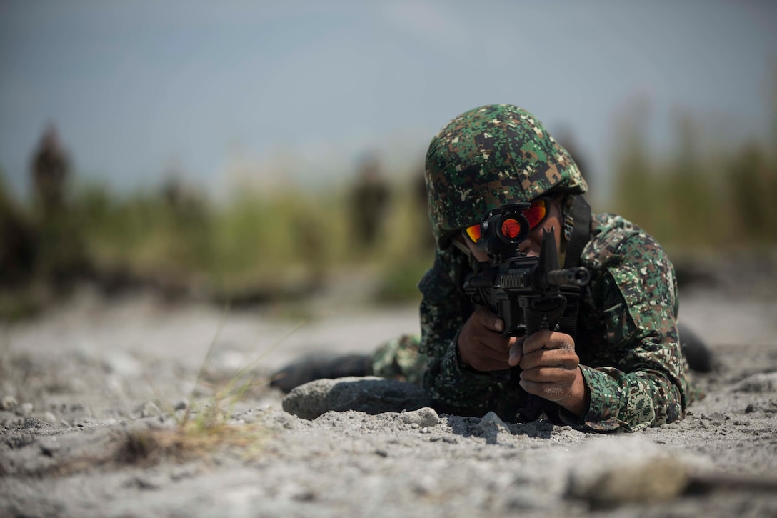 Philippine Marine Corps Pfc. Joel B. Bantog aims his weapon during platoon movement training at Crow Valley, Philippines, Oct. 2, 2015, as part of Amphibious Landing Exercise 2015. Bantog is assigned to the 31st Marine Company, Marine Battalion Landing Team 1. U.S. Marine Corps photo by Lance Cpl. Juan Bustos