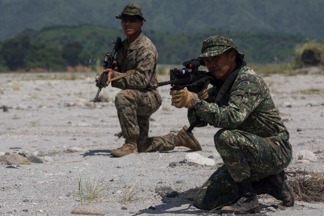 U.S. Marine Corps Cpl. Alfredo Arroyo, left, and Sgt. Garry C. Prande of the Phillipine marines participate in platoon movement training at Crow Valley, Philippines, Oct. 2, 2015, as part of Amphibious Landing Exercise 2015. Arroyo is a squad leader assigned to Echo Company, 2nd Battalion, 5th Marine Regiment. U.S. Marine Corps photo by Lance Cpl. Juan Bustos