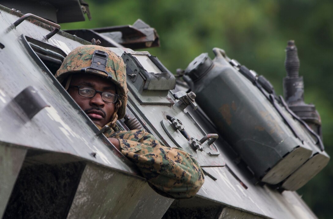 A U.S. Marine drives a light armored vehicle during platoon movement training at Crow Valley, Philippines, Oct. 2, 2015, as part of Amphibious Landing Exercise 2015. U.S. Marine Corps photo by Lance Cpl. Juan Bustos 