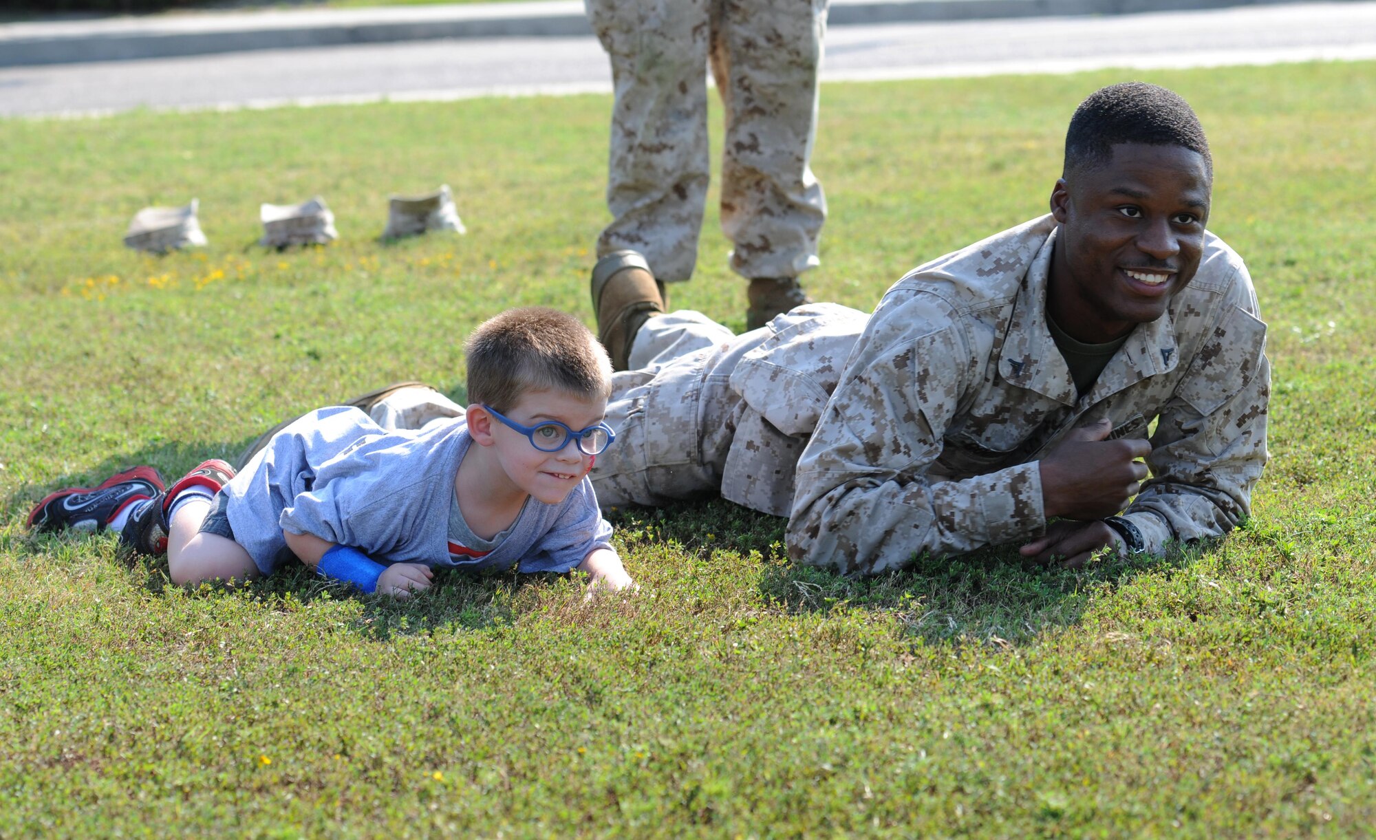 Cael Doehling, son of Tech. Sgt. Morgan Doehling, 338th Training Squadron instructor supervisor, and Lance Cpl. Devin Goodall, Keesler Marine Detachment, participate in a combat fitness test during Operation Hero Oct. 10, 2015, Keesler Air Force Base, Miss. The event was designed to help children better understand what happens when their parents deploy.  (U.S. Air Force photo by Kemberly Groue)