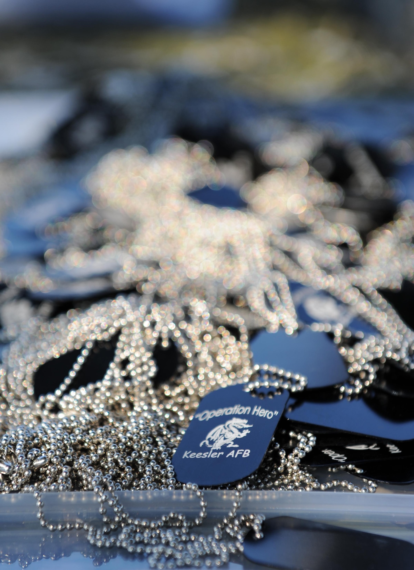 Dog tags lay in bundles on top of a table during Operation Hero Oct. 10, 2015, Keesler Air Force Base, Miss. The event was designed to help children better understand what happens when their parents deploy.  (U.S. Air Force photo by Kemberly Groue)
