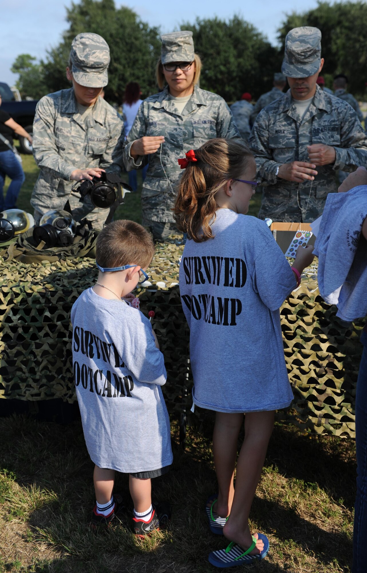 Keesler Airmen volunteer to guide children through the deployment line during Operation Hero Oct. 10, 2015, Keesler Air Force Base, Miss. The event was designed to help children better understand what happens when their parents deploy.  (U.S. Air Force photo by Kemberly Groue)