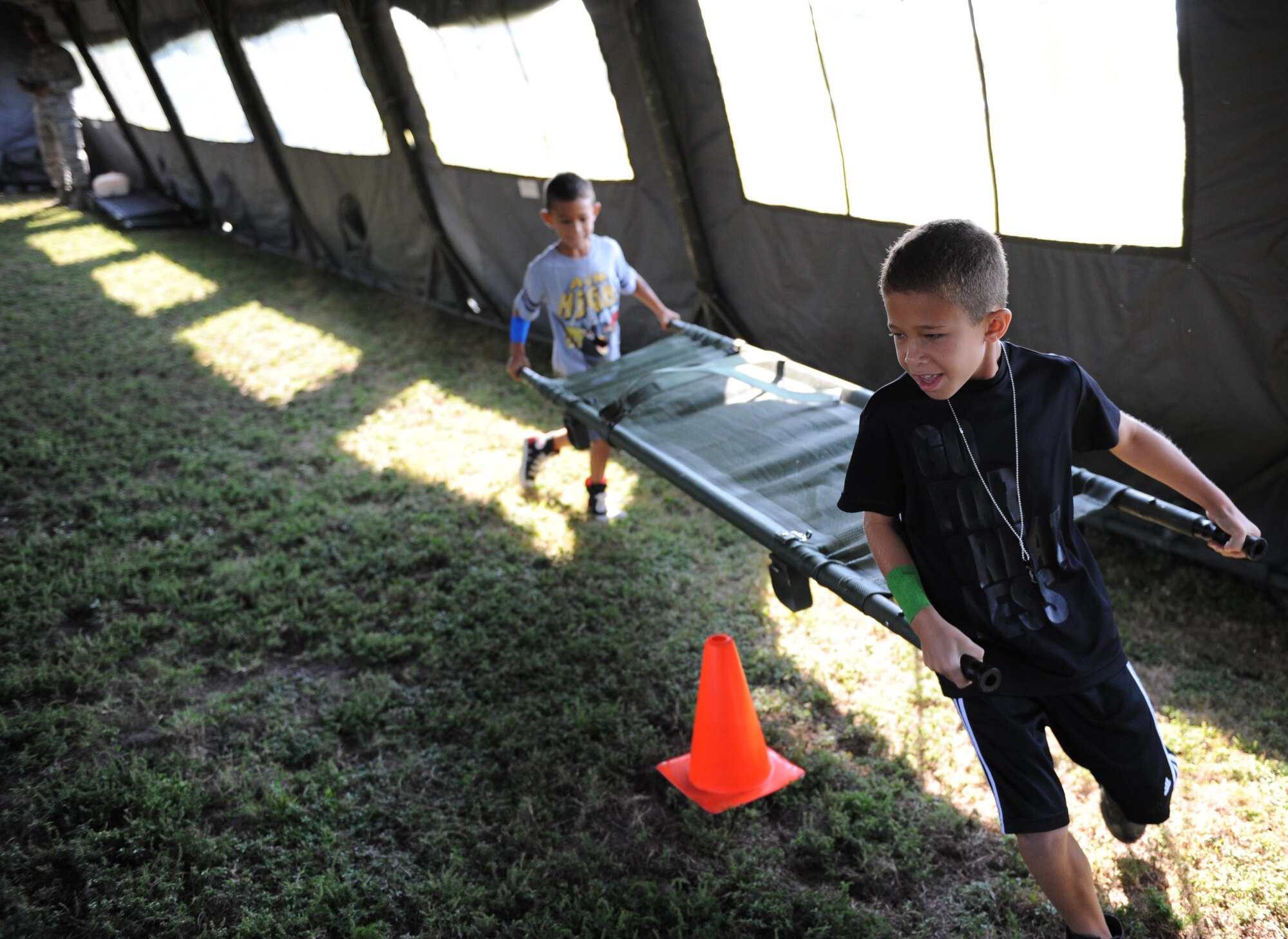 Zane and Dylan Lantz, sons of Capt. Shawn Lantz, 81st Surgical Operations Squadron certified registered nurse anesthetist, participate in a litter carry race during Operation Hero Oct. 10, 2015, Keesler Air Force Base, Miss. The event was designed to help children better understand what happens when their parents deploy.  (U.S. Air Force photo by Kemberly Groue)