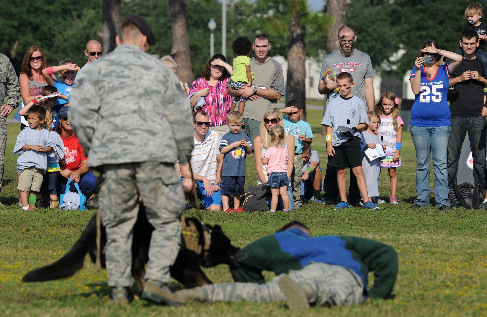 Keesler families watch a military working work demonstration during Operation Hero Oct. 10, 2015, Keesler Air Force Base, Miss. The event was designed to help children better understand what happens when their parents deploy.  (U.S. Air Force photo by Kemberly Groue)