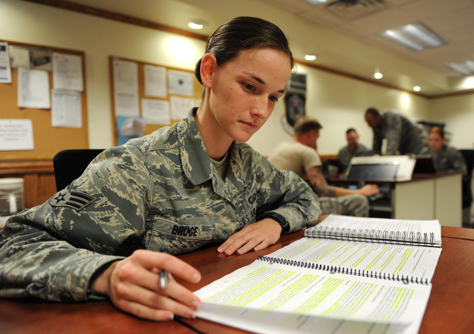 Senior Airman Sarah Bruce, 335th Training Squadron student, reviews class material during the personnel apprentice course at Wolfe Hall Oct. 14, 2015, Keesler Air Force Base, Miss.  Bruce graduated with perfect scores and will be heading to the 311th Training Squadron, Presidio of Monterey, Calif., Army Base. (U.S. Air Force photo by Kemberly Groue)