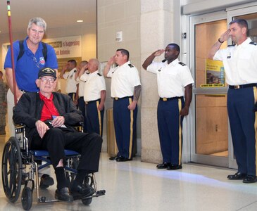 Retired Army Col. Tom Morris is wheeled through the San Antonio International Airport after a late-night return from an honor flight to Washington, D.C. Oct. 3. Morris is a 105-year-old veteran of World War II who fought at Normandy and the Battle of the Bulge.