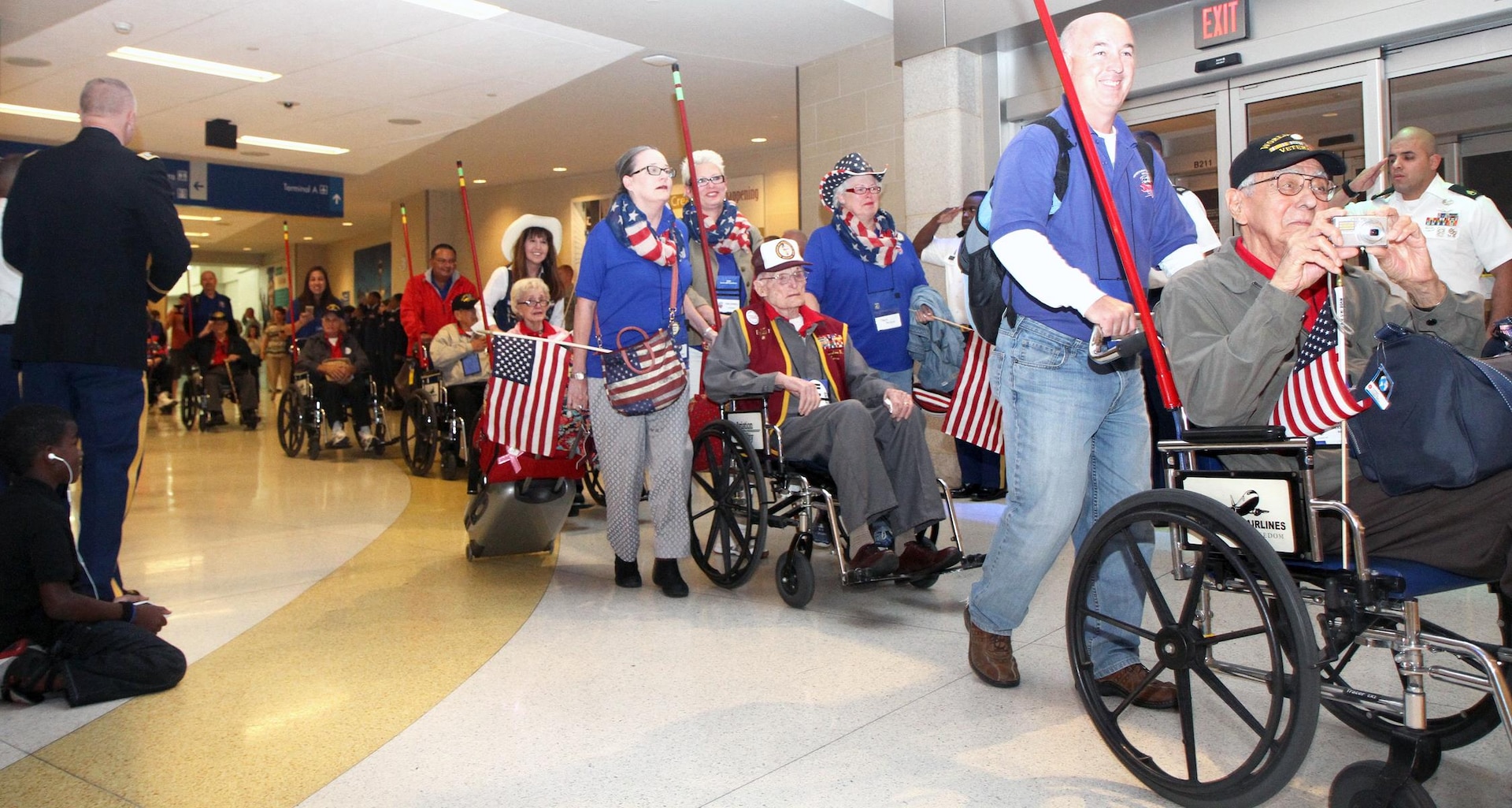 Retired Army Col. Tom Morris is wheeled through the San Antonio International Airport after a late-night return from an honor flight to Washington, D.C. Oct. 3. Morris is a 105-year-old veteran of World War II who fought at Normandy and the Battle of the Bulge.