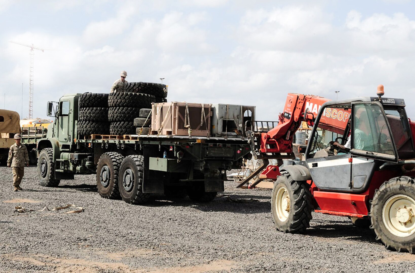 Personnel prepare to unload excess and scrap tires and equipment on Camp Lemonnier, Djibouti, Oct. 16. The camp is undertaking a first-ever massive cleanup effort to reduce excess and scrap material on the base with the support of the Defense Reutilization & Marketing Service.