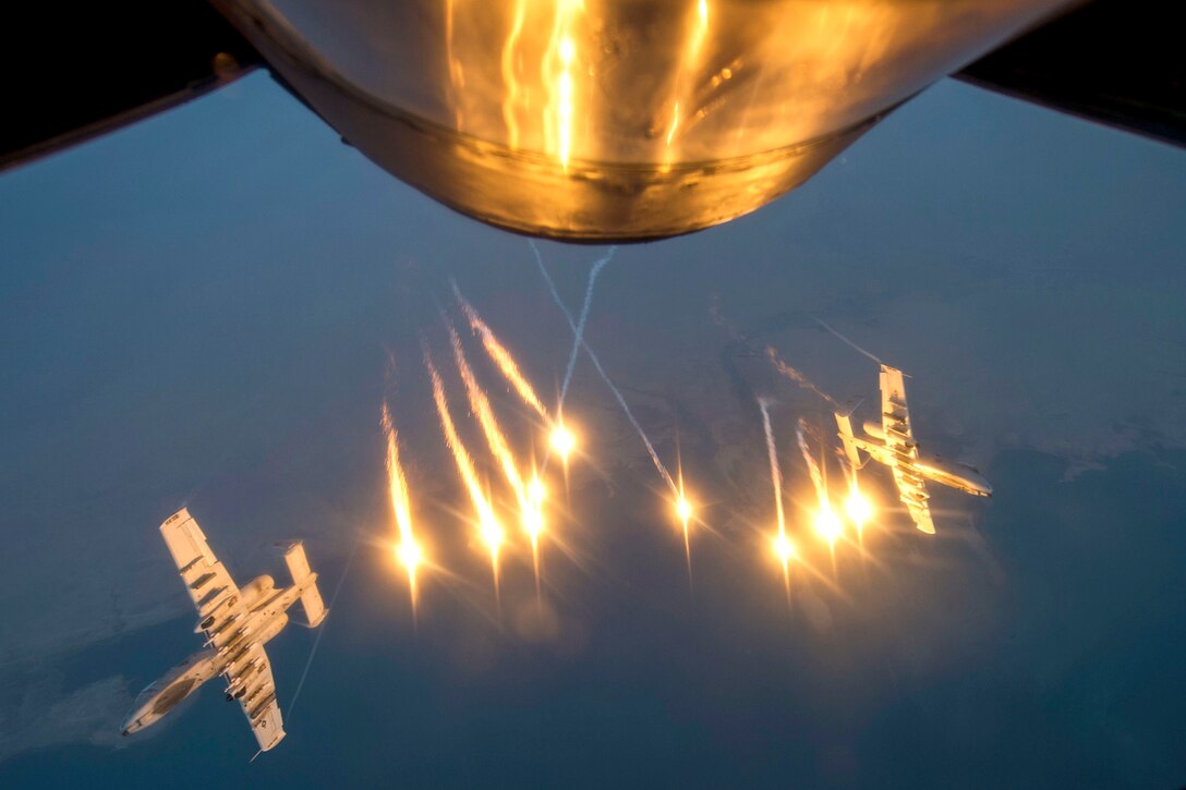 Two U.S. Air Force A-10 Warthogs release flares after receiving fuel from a KC-135 Stratotanker over southwest Asia, Oct. 13, 2015. The Warthogs are assigned to the 163rd Expeditionary Fighter Squadron and the Stratotanker to the 340th Expeditionary Aerial Refueling Squadron. Coalition forces fly daily missions in support of Operation Inherent Resolve. U.S. Air Force photo by Senior Airman Taylor Queen