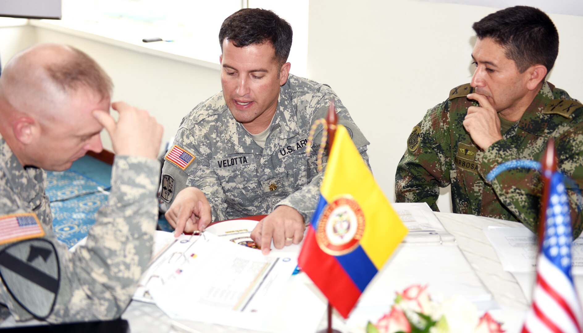 Maj. Bradley Velotta (center), regional affairs directorate translates for Col. Joseph Smith (left),  Headquarters Department of the Army Intelligence (G-2), questions from Col. Carlos Augusto Barbossa (right), Colombian Army Director of Organization Plans and International Relations.