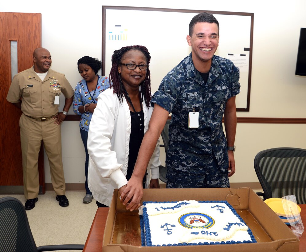 Retired Navy Capt. Patricia Montgomery, family nurse practitioner, and Hospital Apprentice Kailex Pipkins, primary care services, Naval Branch Health Clinic Albany, share in a cake-cutting at Marine Corps Logistics Base Albany, Oct. 13. The event was one of several activities held in celebration of the Navy’s 240th birthday.