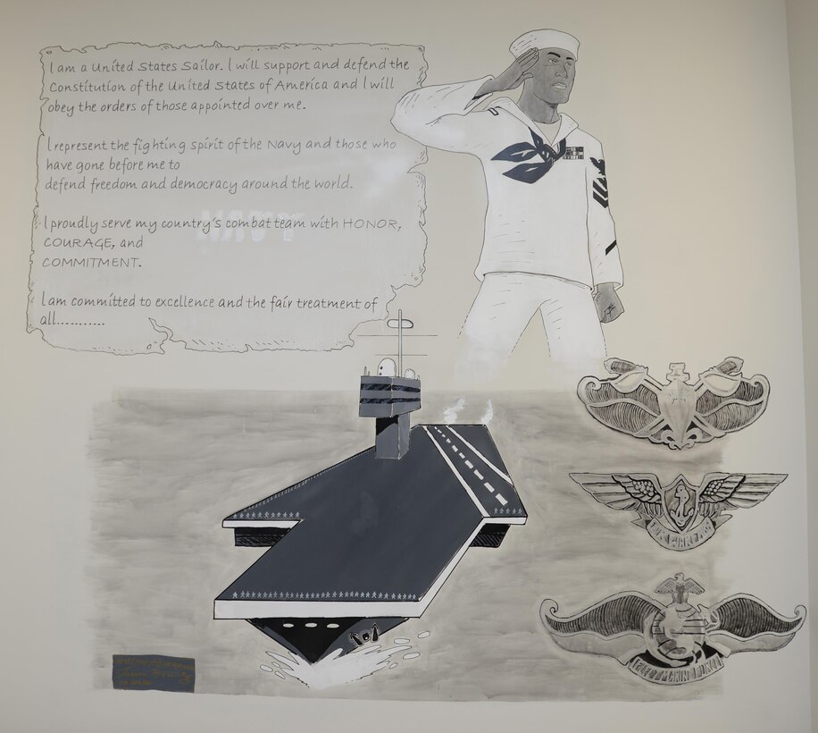 A mural of the Navy Sailors’ Creed appears on a wall inside the staff lounge at the Naval Branch Health Clinic Albany aboard Marine Corps Logistics Base Albany. Sailors as well as civilian personnel at the clinic gathered in and around the lounge to feast and converse during a celebration of the Navy’s 240th birthday, here, Oct 13.
