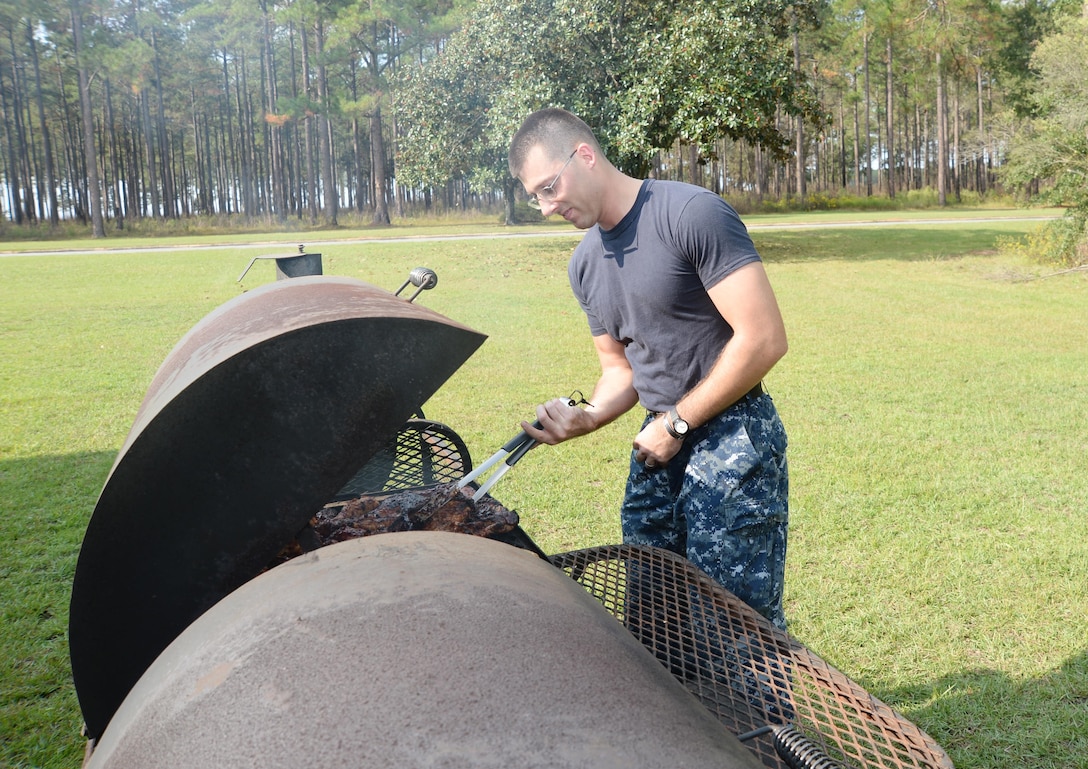 Petty Officer 2nd Class William Beers, leading petty officer, administrative/records, Naval Branch Health Clinic Albany, works as the 'grill master' cooking chicken, beef and ribs for the Navy’s 240th birthday celebration at Marine Corps Logistics Base Albany, Oct. 13. Beers, a nine-year Navy corpsman, said he was excited to have the clinic’s leadership from Naval Hospital Jacksonville, Fla., visiting and sharing in NBHC Albany’s day of celebration.
