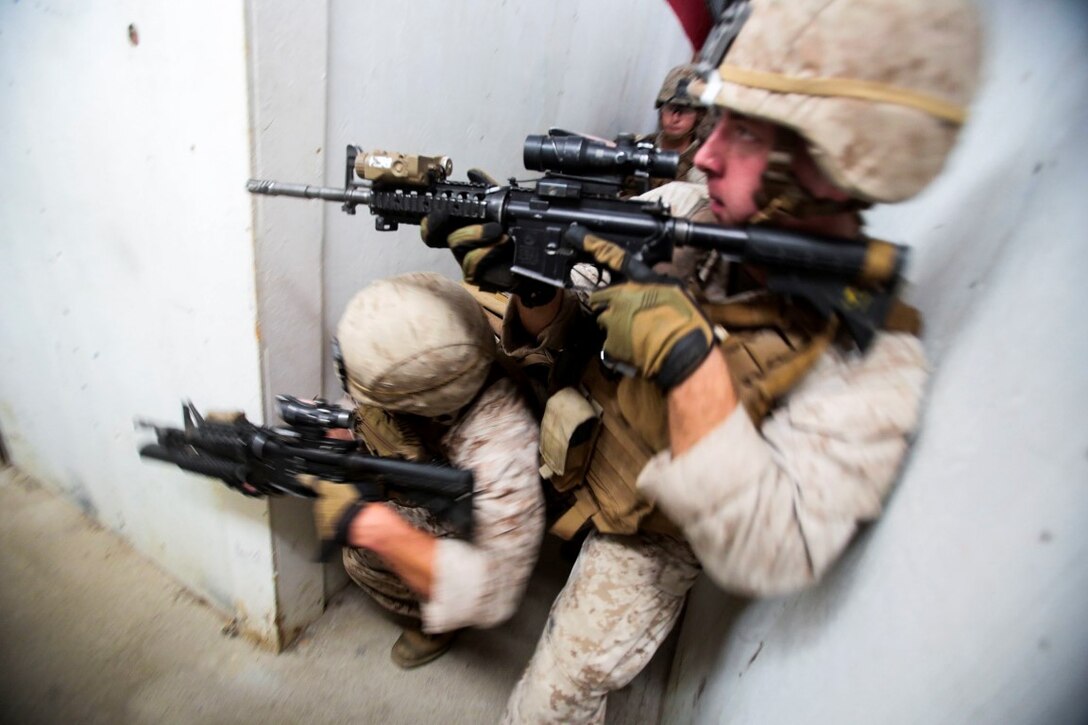 Marines assigned to the Urban Leaders Course at 1st Marine Division Schools, I Marine Expeditionary Force, clear a hallway during a live-fire training exercise aboard Marine Corps Base Camp Pendleton, Calif., Sept. 25, 2015. The class teaches fire team and squad leaders skills and tactics to be successful in urban environments, which they can share with the Marines they lead and the leadership of their entire unit. (U.S. Marine Corps photo by Lance Cpl. Caitlin Bevel)