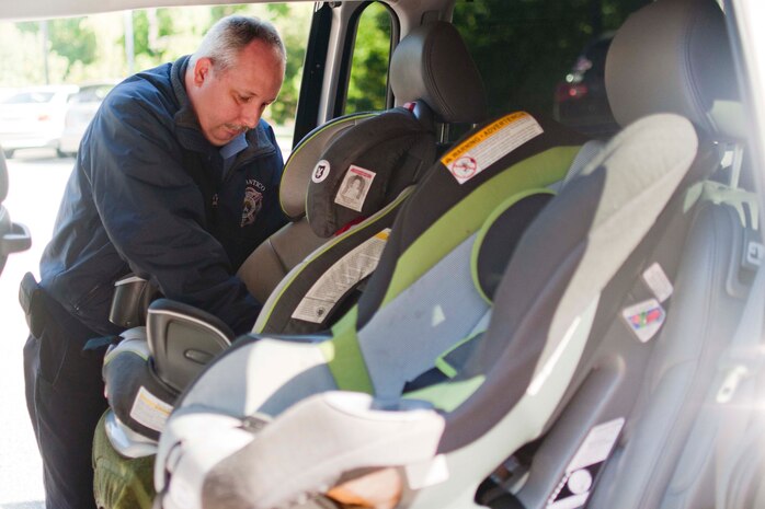 Sgt. James L. Thacker III, Fire Station 531 car seat technician, inspects child car seats Oct. 6 at the Child Development Center North. The Parent Advisory Board hosted the free safety checks aboard Marine Corps Base Quantico.