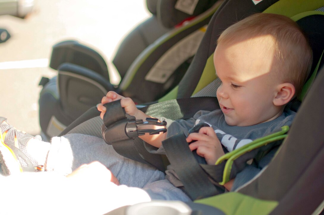 Matthew, whose father is stationed at Marine Corps Intelligence Activity, buckles up after having his car seat checked by Fire Station 531 car seat technician at the Child Development Center North, Oct. 6. The Parent Advisory Board hosted a free child car seat safety checks in conjunction with the Security Battalion. 