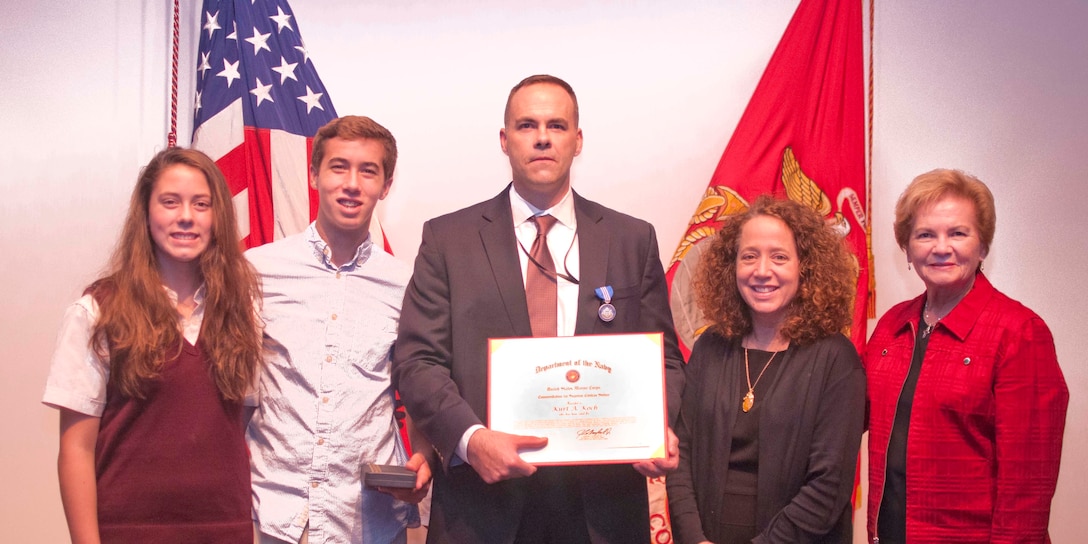 Emma Koch, Robbie Koch, awardee Kurt Koch, Frances Koch and Patricia Koch attend The Superior Civilian Service Award presentation ceremony Oct. 6 at The Raymond G. Davis Center aboard Marine Corps Base Quantico. 

