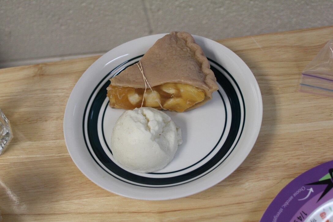 A correctly-sized portion of holiday dessert: 1/8 of a nine-inch pie and 1/2 cup of ice cream.