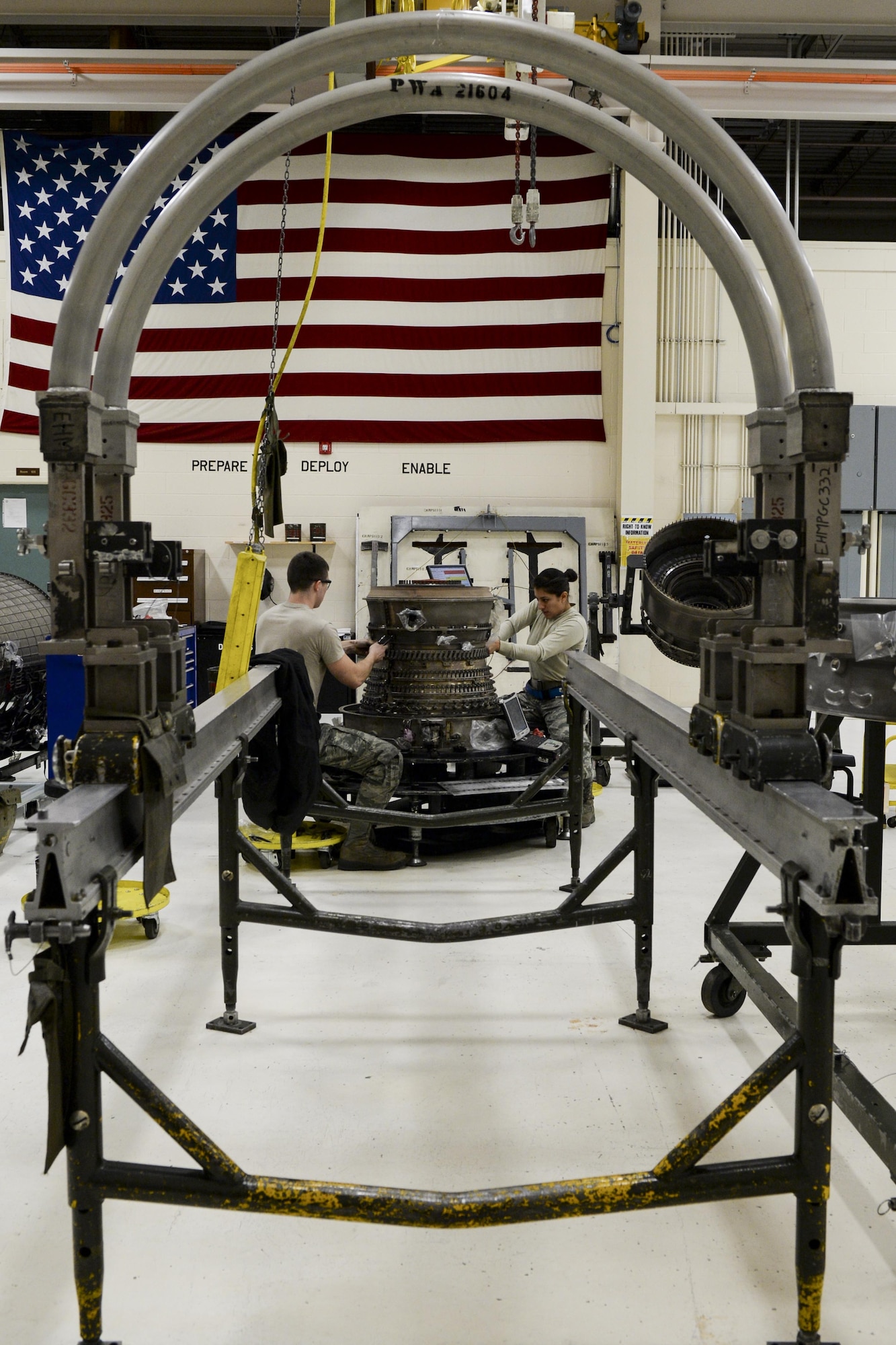 U.S. Air Force Senior Airman Cody Bowman, an aerospace propulsion journeyman, and Staff Sgt. Catalina Cornejo, an aerospace propulsion craftsman, both assigned to the 354th Maintenance Squadron, disassemble an F110-GE-100C jet engine Oct. 8, 2015, during an engine rebuild in the Engine Shop at Eielson Air Force Base, Alaska. Bowman and Cornejo participated in an engine rebuild to find and replace any worn components. (U.S. Air Force photo by Senior Airman Peter Reft/Released)