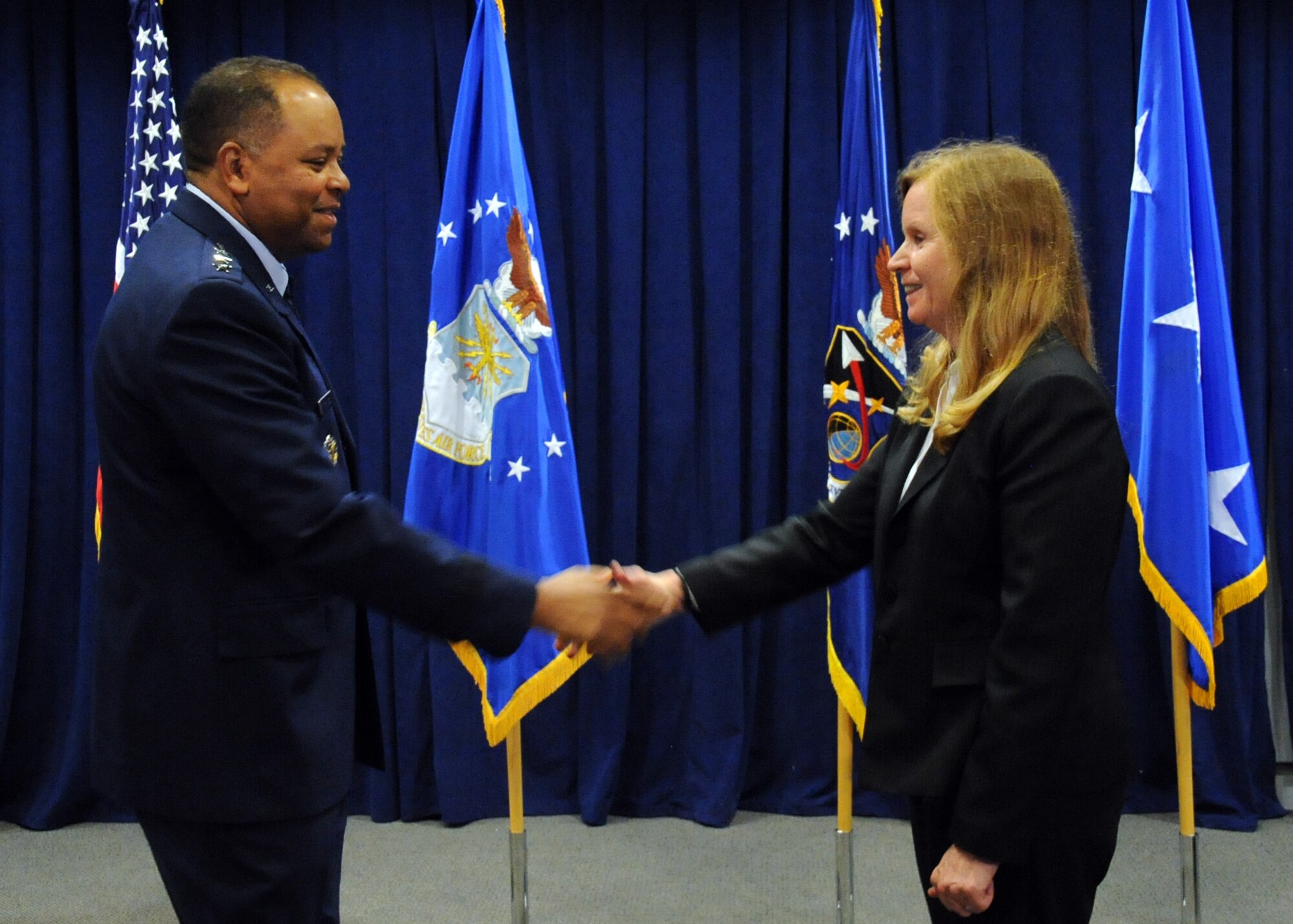 Lt. Gen. Samuel Greaves, Space and Missile Systems Center commander and Air Force Program Executive Officer for Space congratulates Dr. Claire Leon, the first director of the Launch Systems Enterprise Directorate on officially assuming her leadership role during the stand-up of the organization, Oct. 14.