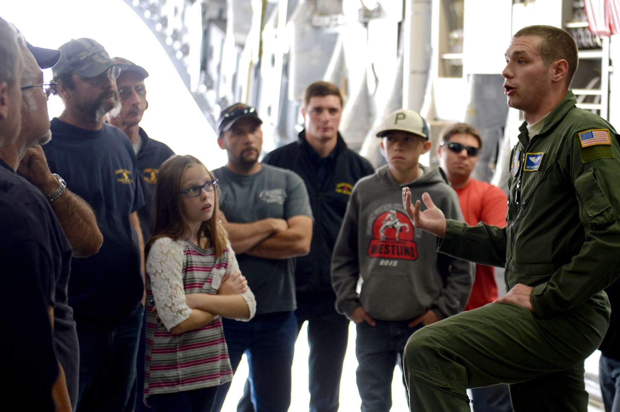 Staff Sgt. Mathew Vanourek, 728th Airlift Squadron loadmaster, speaks with members of the Grant County fire department during a C-17 Globemaster III tour at Moses Lake, Wash., Oct. 9, 2015. The Grant County fire department may have to respond to a C-17 aircraft accident if one happens on Moses Lake. (U.S. Air Force photo/Senior Airman Divine Cox)