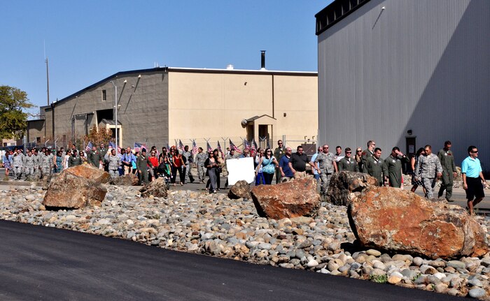 Family, friends and members of Team Beale walk out to the flight line to greet the returning deployed Airmen Oct. 13, 2015, Beale Air Force Base, California. The returning group of Airmen represent the 427th and 306th Reconnaissance Squadrons and completed the final MC-12 deployment from Beale. (U.S. Air Force photo by Staff Sgt. Jeffrey M. Schultze)