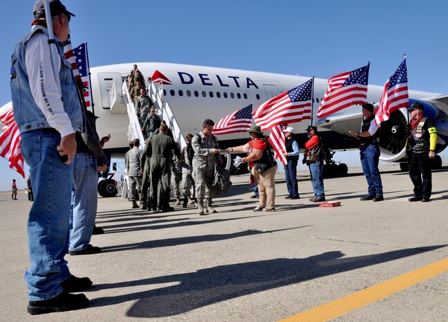 The Patriot Guards volunteer group and Beale Airmen greet returning aircrew after their recent 6-month deployment to Afghanistan in support of Operation Enduring Freedom utilizing the MC-12W Liberty aircraft Oct. 13, 2015, at Beale Air Force Base, California. The returning group of Airmen represent the 427th and 306th Reconnaissance Squadrons and completed the final MC-12 deployment from Beale. (U.S. Air Force photo by Staff Sgt. Jeffrey M. Schultze)