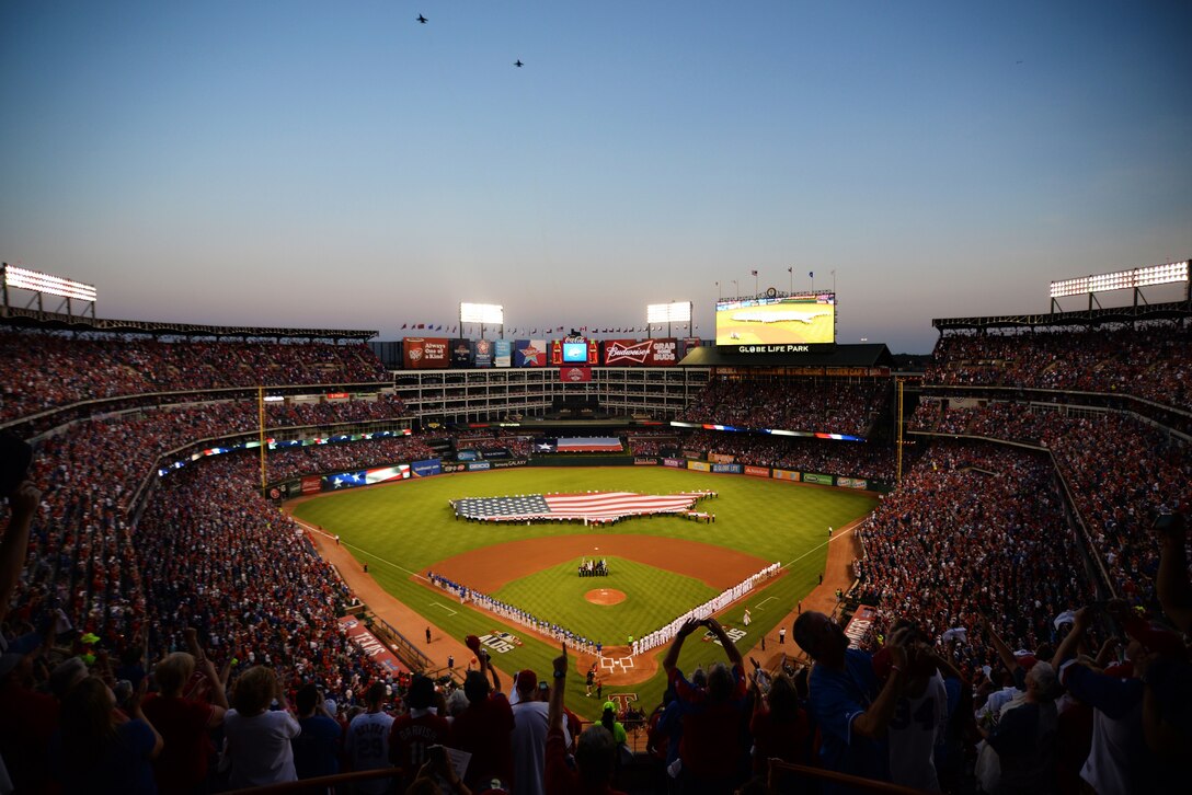 The Sheppard Air Force Base Honor Guard present the Colors during the opening ceremonies of game three of the American League Division Series where the Texas Rangers hosted the Toronto Blue Jays at Globe ,Life Park in Arlington, Texas, Oct. 11, 2015. The flag in the outfield is handled by more than 125 joint service members stationed in Texas. (U.S. Air Force photo/Senior Airman Robert McIlrath). 