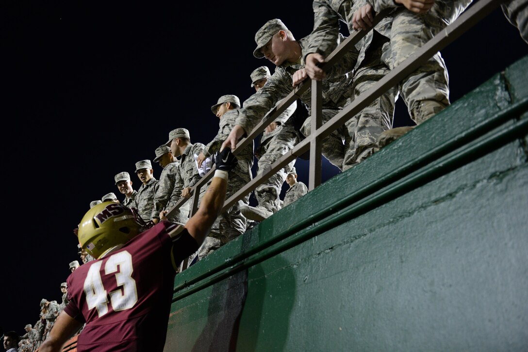 Adam Hill, Midwestern State University linebacker, thanks Sheppard Airmen for coming to the game and cheering them on to a victory against West Texas A&M Oct. 10, 2015, at Memorial Stadium, Wichita Falls, Texas. Sheppard Airmen and Soldiers from Ft. Sill, Okla., were invited to the game as part of the annual military appreciation event.  (U.S. Air Force photo/Tech. Sgt. Mike Meares)