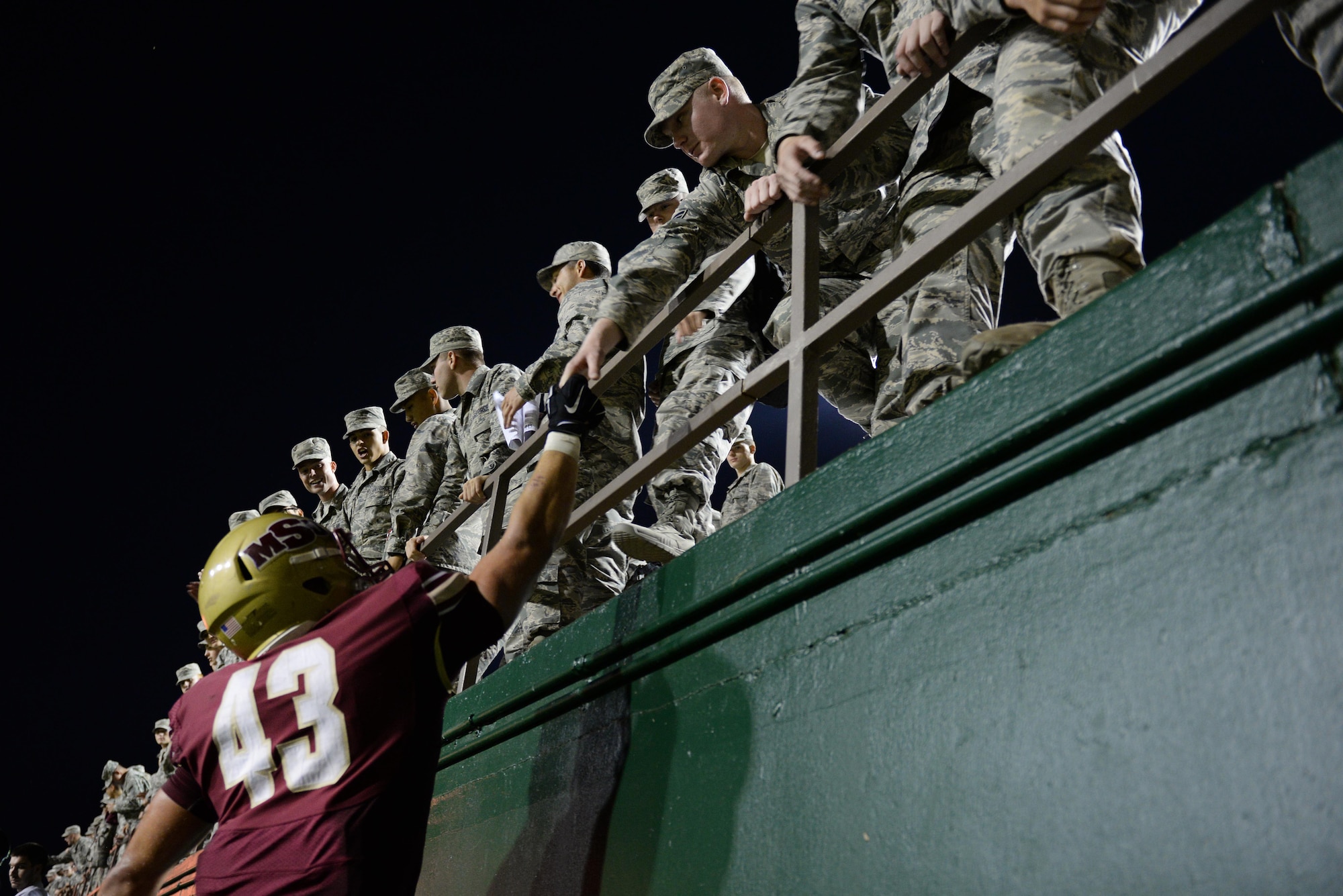 Adam Hill, Midwestern State University linebacker, thanks Sheppard Airmen for coming to the game and cheering them on to a victory against West Texas A&M Oct. 10, 2015, at Memorial Stadium, Wichita Falls, Texas. Sheppard Airmen and Soldiers from Ft. Sill, Okla., were invited to the game as part of the annual military appreciation event.  (U.S. Air Force photo/Tech. Sgt. Mike Meares)