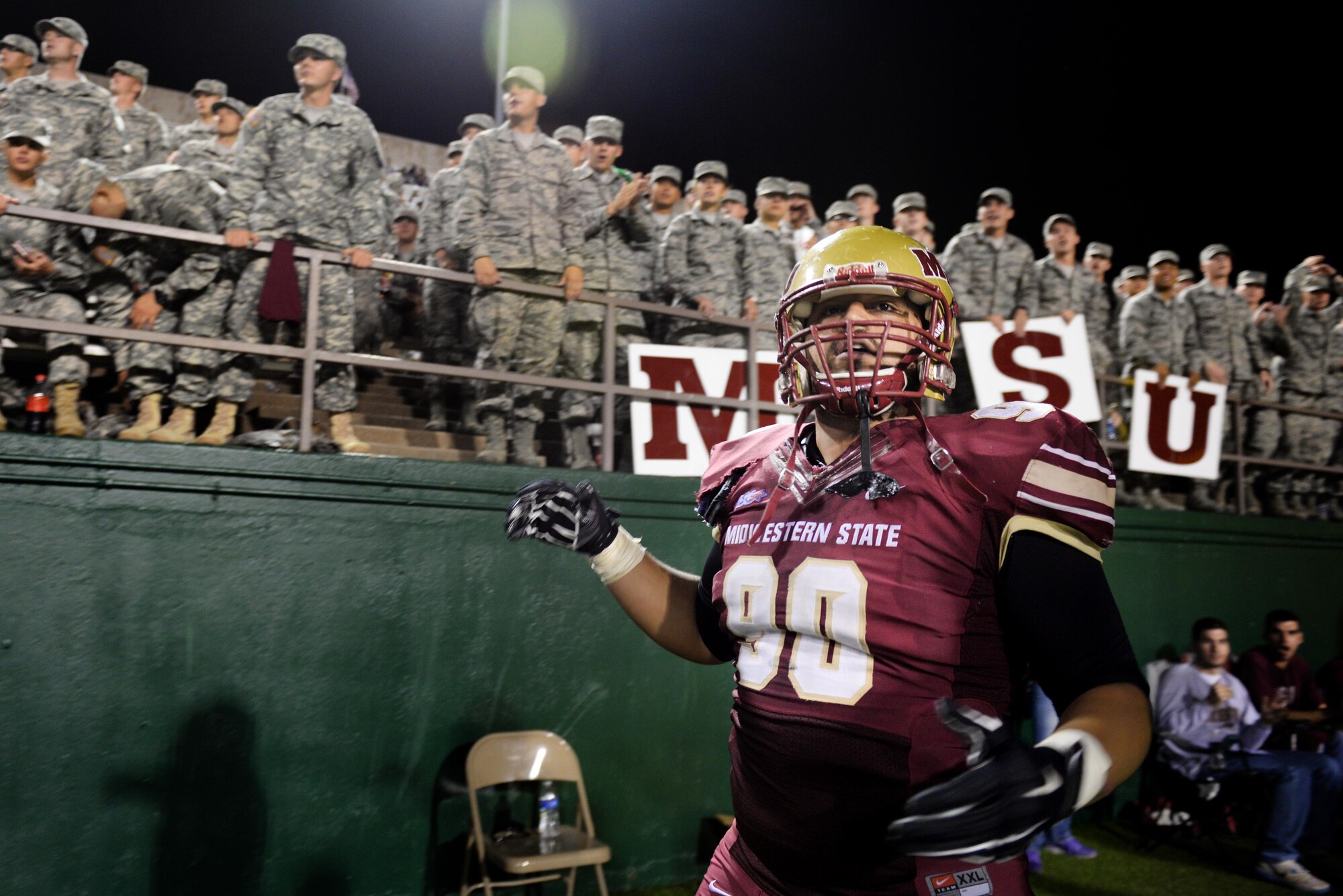 Cory Faiva, Midwestern State University defensive lineman, urges the crowd in front of the military section to cheer as the Mustangs offense is preparing to score a touchdown during the military appreciation game at Memorial Stadium in Wichita Falls, Texas, Oct. 10, 2015.  Vincent Jackson, Mustangs running back, put a stamp on the win over West Texas A&M with an 84-yard touchdown run in the fourth quarter, 24-17. (U.S. Air Force photo/Tech. Sgt. Mike Meares)