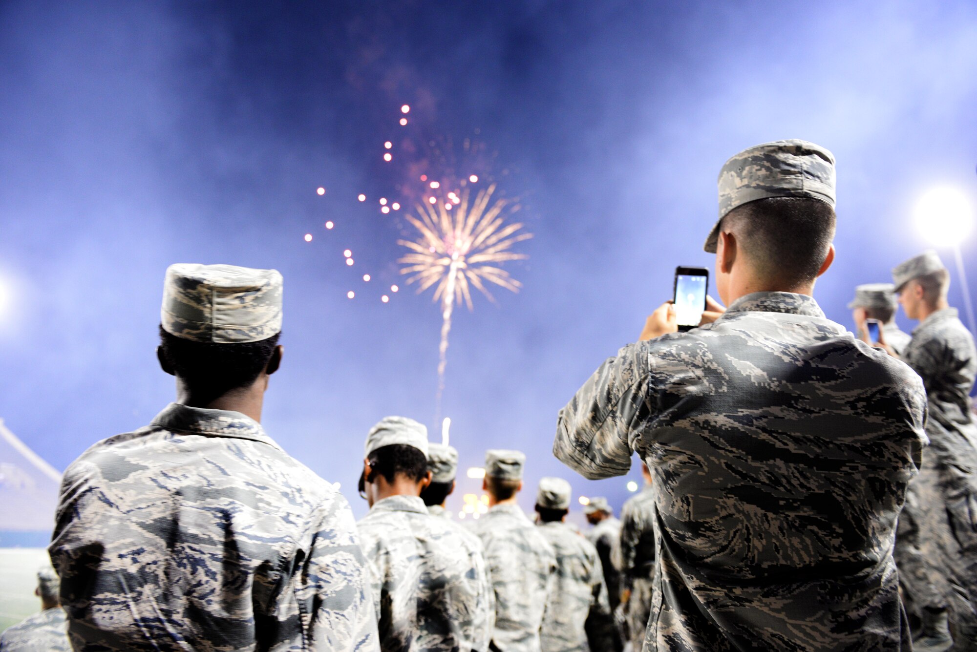 Airman-in-Training from Sheppard Air Force Base look on during the halftime show at Midwestern State University?s military appreciation night at Memorial Stadium in Wichita Falls, Texas, Oct. 10, 2015.  Sheppard Airmen and Soldiers from Ft. Sill, Okla., were invited to the game to cheer on the Mustangs in their 24-17 win over West Texas A&M. (U.S. Air Force photo/Tech. Sgt. Mike Meares)