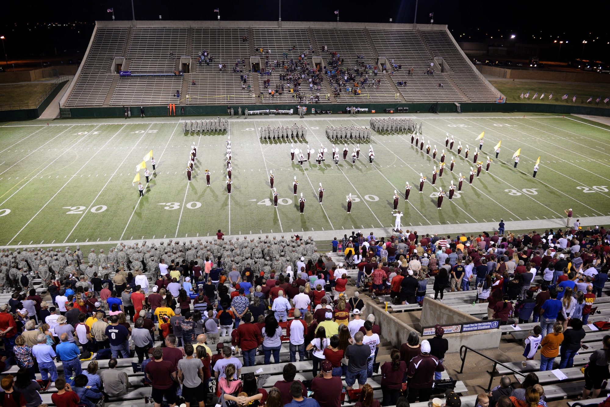 Sheppard Airmen and Soldiers from Ft. Sill, Okla., stand in formations during the Midwestern State University halftime show at the military appreciation game Oct. 10, 2015. More than 500 service members cheered the MSU Mustangs in their 24-17 win over West Texas A&M. (U.S. Air Force photo/Tech. Sgt. Mike Meares)