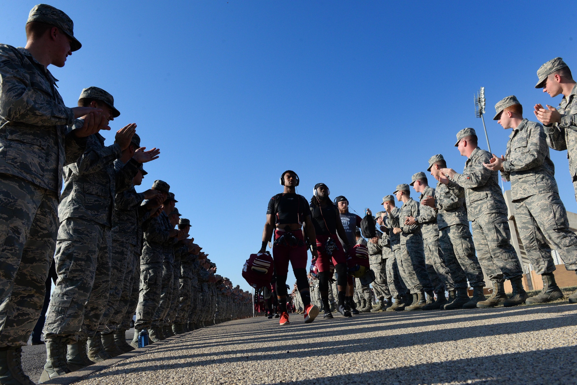 Airmen from Sheppard Air Force Base, Texas, cheer the Midwestern State university football during the ?Mustang Walk? at Wichita Falls Memorial Stadium, Wichita Falls, Texas, Oct. 10, 2015. Sheppard Airmen and Soldiers from Ft. Sill, Okla., were invited to the military appreciation game to cheer on the Mustangs in their 24-17 win over West Texas A&M. (U.S. Air Force photo/Tech. Sgt. Mike Meares)