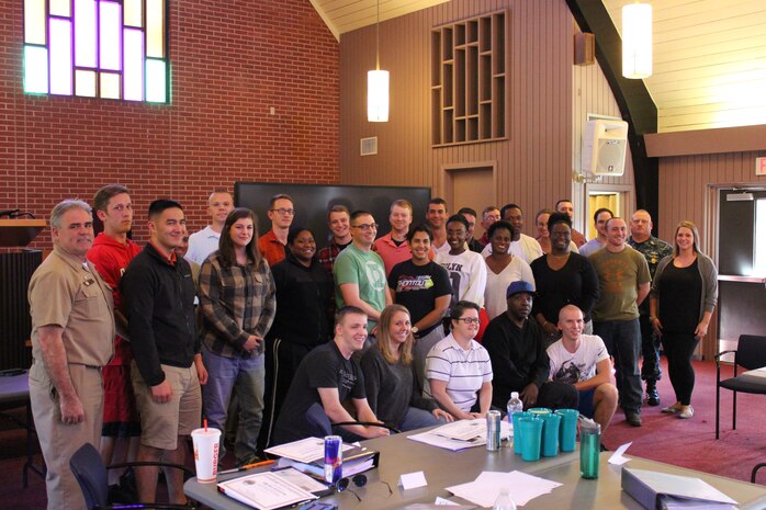 Capt. Tim Sparks, deputy commander of Joint Base Charleston (left), and Command Master Chief Joe Gardner from Naval Support Activity join Ruby Godley, Sexual Assault Response Coordinator (Right),  to recognize 28 service members, representing each of the Navy's mission partners, after completing Sexual Assault Prevention and Response Initial Victim Advocate Training on October 9, 2015 at JB Charleston – Weapons Station.  After receiving certification through the National Organization of Victim Assistance, these newly trained Victim Advocates will serve on the 24/7 SAPR Watchbill and be able to respond to victims of sexual assault.  