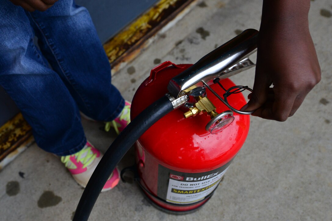 Children learn how to properly operate a fire extinguisher during the fire department’s open house at Fort Eustis, Va., Oct. 10, 2015. The open house was part of this year’s Fire Prevention Week, which featured the theme of “Hear the Beep, Where you Sleep. “ (U.S. Air Force photo by Staff Sgt. Natasha Stannard/Released)