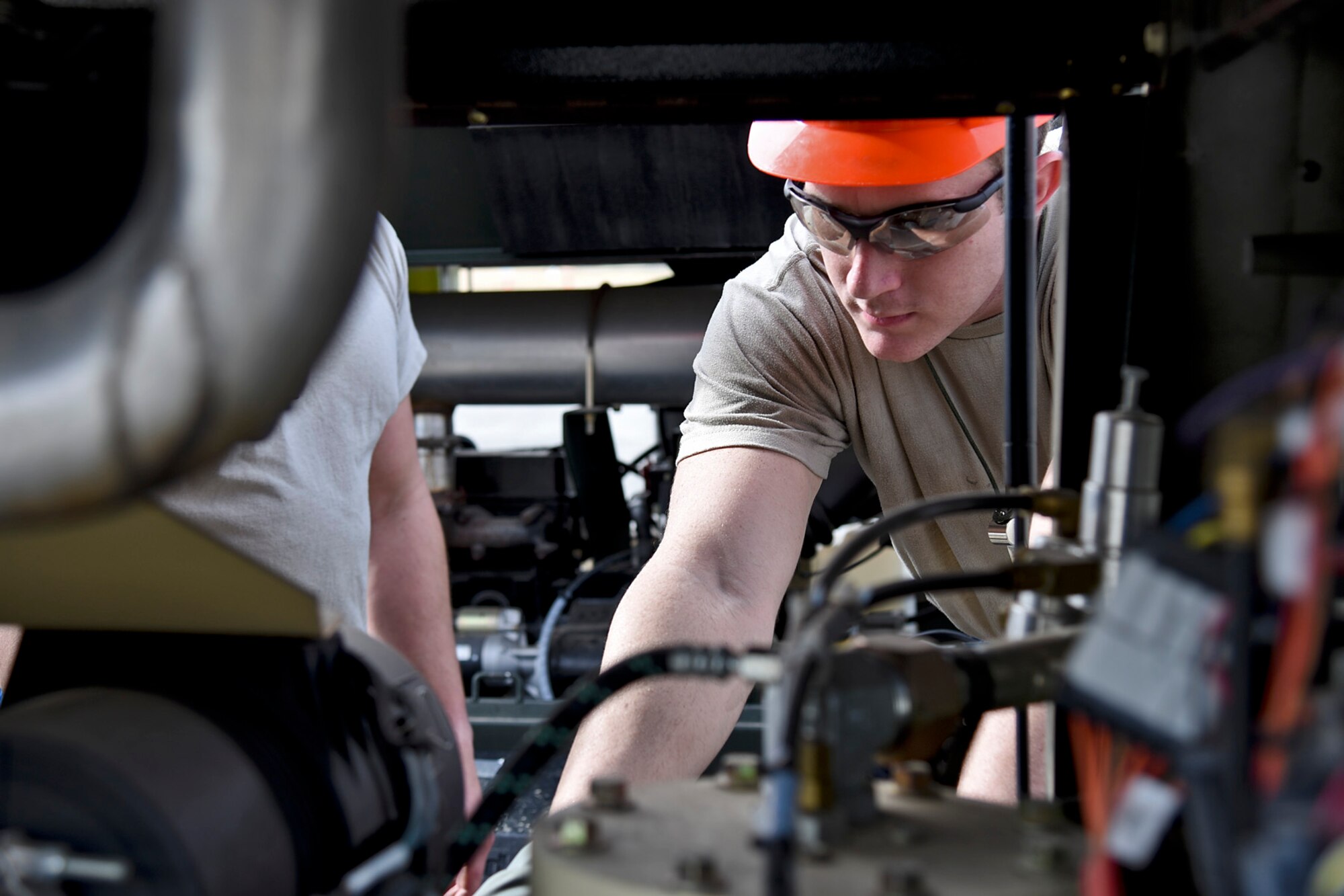 Senior Airman Eric Brown, 92nd Maintenance Squadron aero repair journeyman, conducts the pre-use inspection of the MC-7 air cart which supplies air to the airbags during the Crash, Damaged, Disabled Aircraft Recovery training lift Oct. 9, 2015, at Fairchild Air Force Base, Wash. The CDDAR proficiency training simulated a scenario in which a KC-135 Stratotanker made contact with the ground without the nose landing gear extended. (U.S. Air Force photo/Airman 1st Class Mackenzie Richardson)